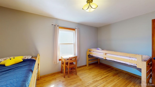bedroom featuring light wood-type flooring and baseboards