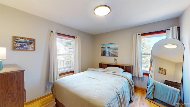 bedroom featuring baseboards and light wood finished floors