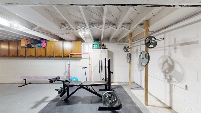 workout room featuring concrete block wall