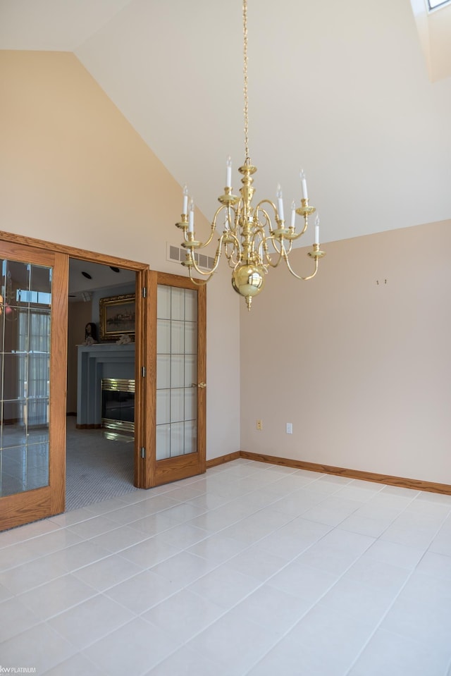 spare room with visible vents, high vaulted ceiling, baseboards, a notable chandelier, and light tile patterned flooring