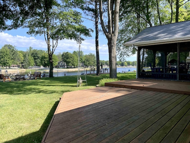 wooden deck featuring a lawn and a water view