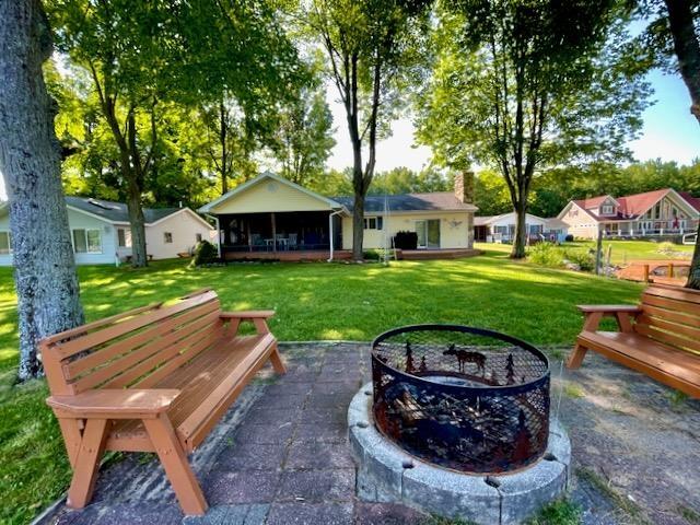 view of yard featuring an outdoor fire pit and a patio area