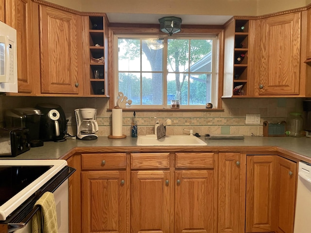 kitchen featuring open shelves, a sink, decorative backsplash, and white appliances