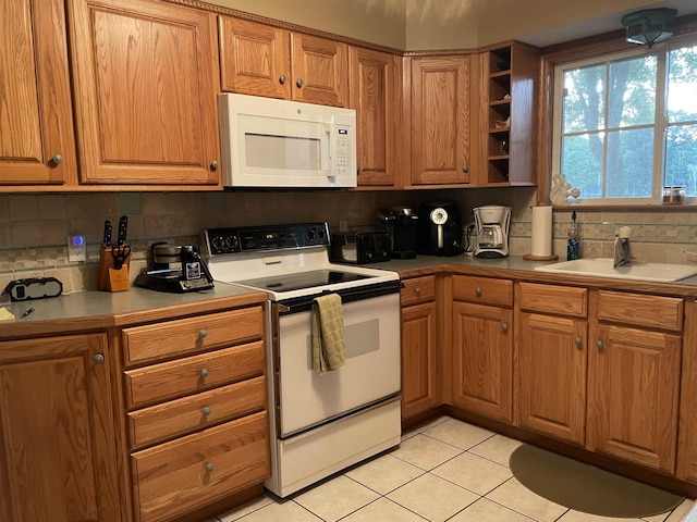 kitchen featuring open shelves, a sink, white appliances, light tile patterned floors, and backsplash