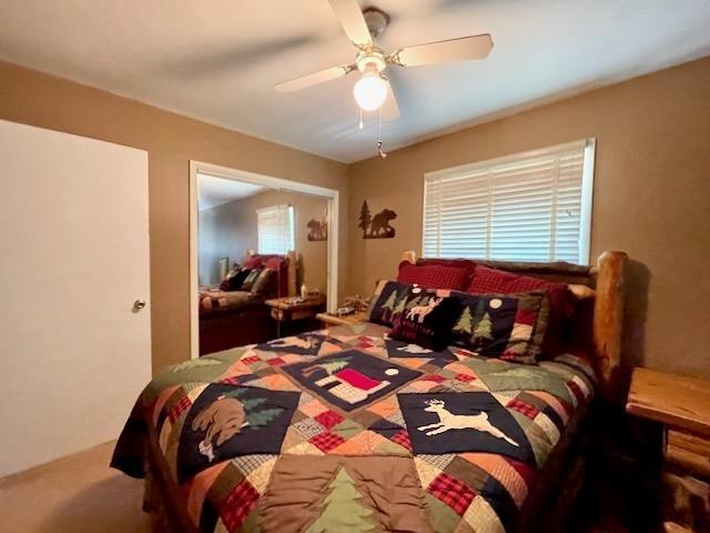 carpeted bedroom featuring ceiling fan