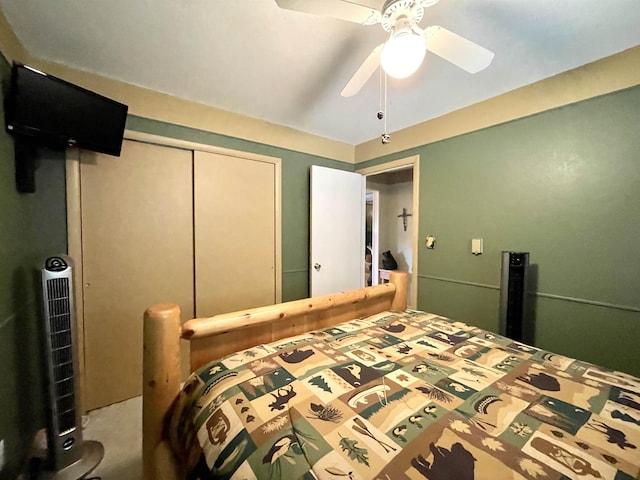 carpeted bedroom with a closet and ceiling fan