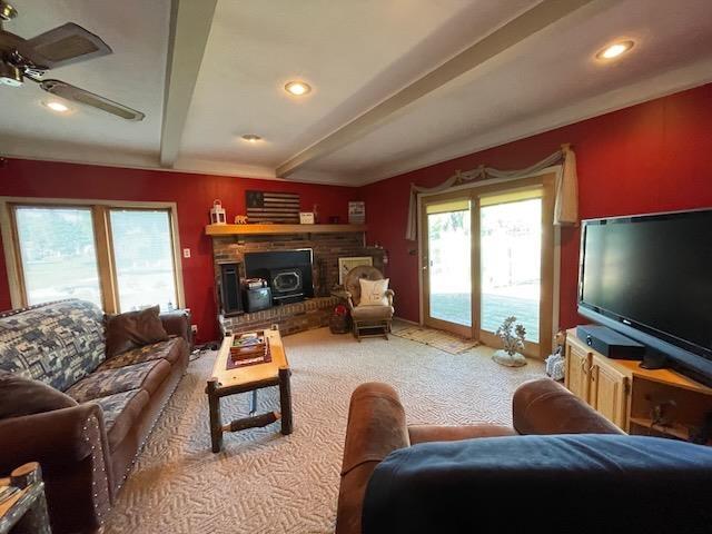 living area featuring carpet floors, recessed lighting, and beamed ceiling