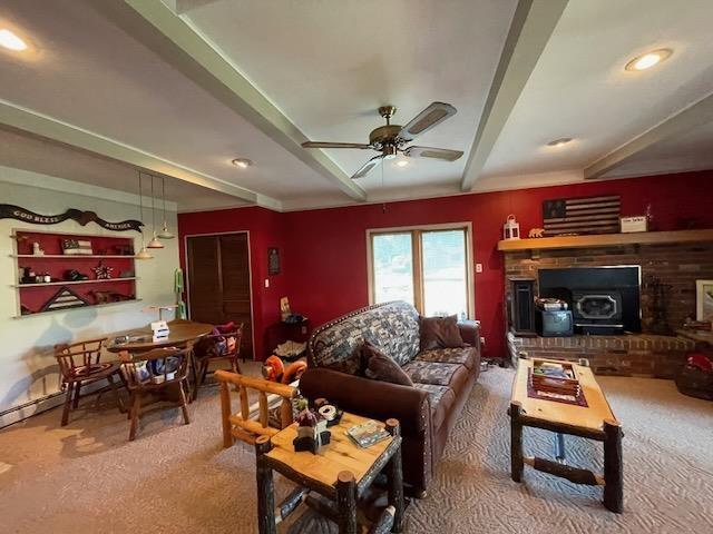 carpeted living room featuring a ceiling fan and beam ceiling