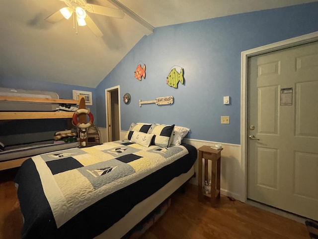 bedroom with a wainscoted wall, ceiling fan, vaulted ceiling, and wood finished floors