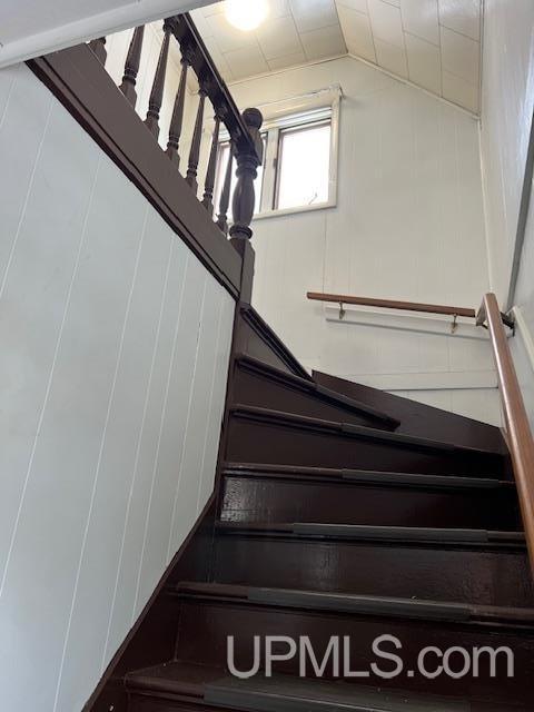 staircase with lofted ceiling