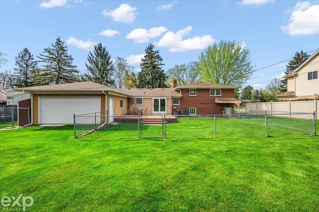 back of property featuring a lawn, a fenced backyard, and an attached garage