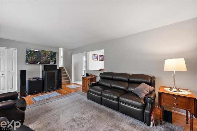 living area with stairs and light wood-type flooring