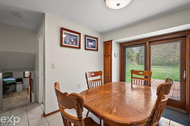 dining area with light tile patterned floors and baseboards