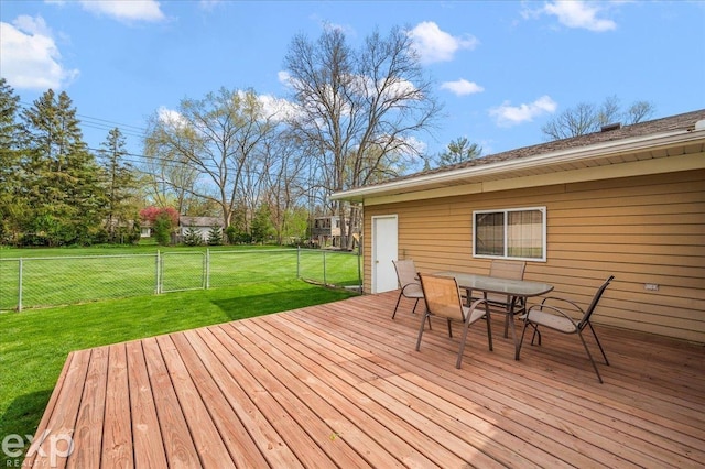 deck featuring fence, outdoor dining space, and a lawn