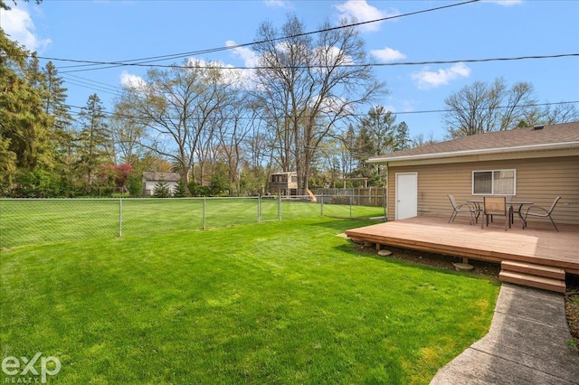view of yard with outdoor dining area, a fenced backyard, and a wooden deck
