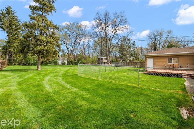 view of yard featuring a wooden deck and fence