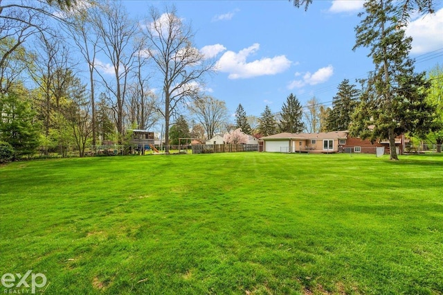 view of yard with fence and a playground
