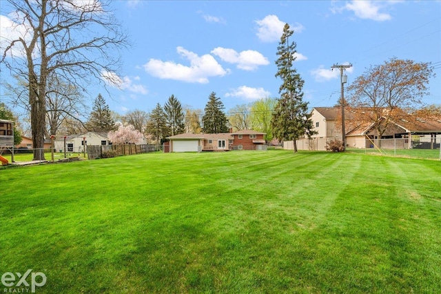 view of yard with a garage and fence