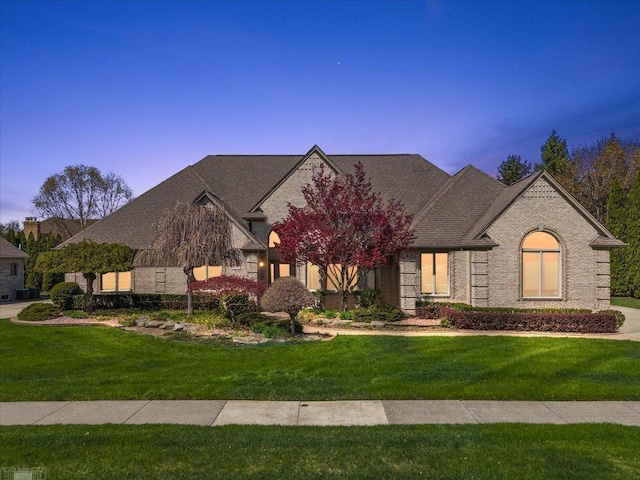 15113 Totten Pl, Shelby Twp, MI 48315 - french country inspired facade with brick siding and a front yard