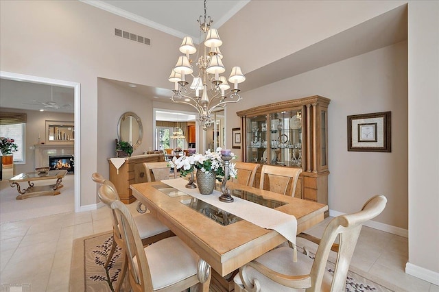 15113 Totten Pl, Shelby Twp, MI 48315 - dining space featuring a premium fireplace, a chandelier, baseboards, light tile patterned floors, and visible vents