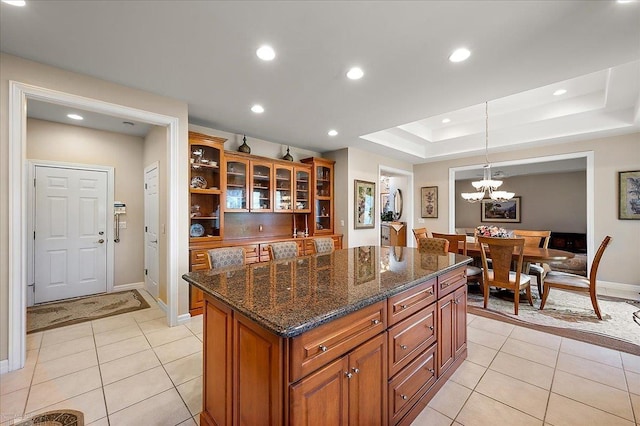 15113 Totten Pl, Shelby Twp, MI 48315 - kitchen with brown cabinetry, light tile patterned floors, a kitchen island, pendant lighting, and glass insert cabinets