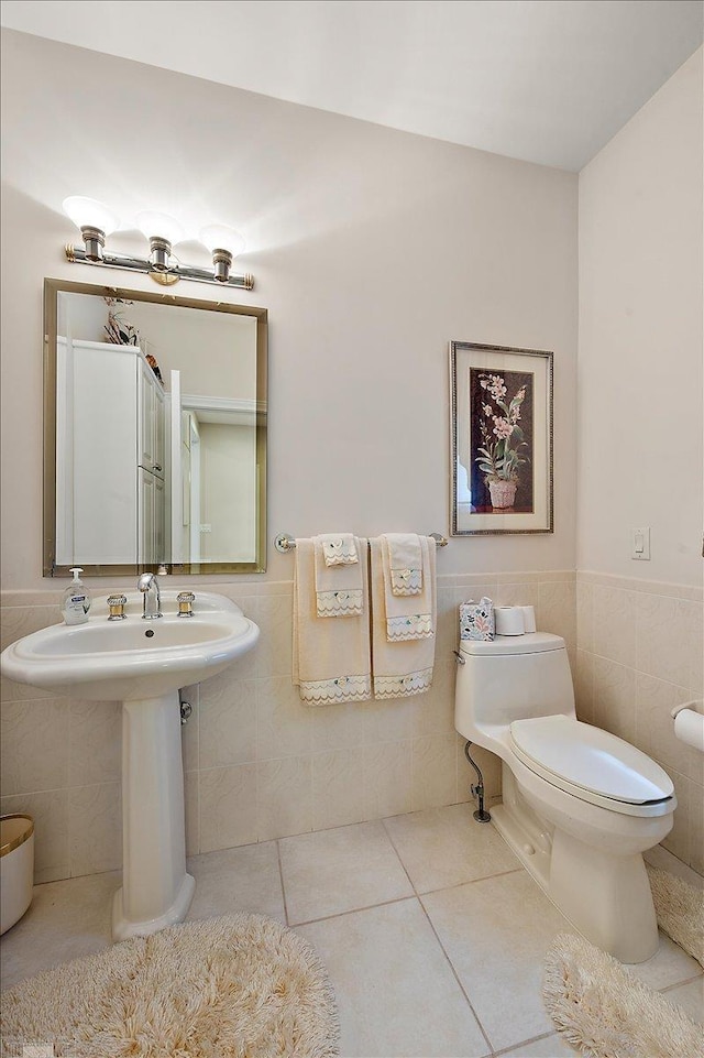 15113 Totten Pl, Shelby Twp, MI 48315 - bathroom featuring toilet, tile patterned floors, tile walls, and a wainscoted wall