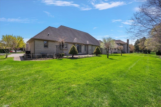 15113 Totten Pl, Shelby Twp, MI 48315 - rear view of house with a lawn