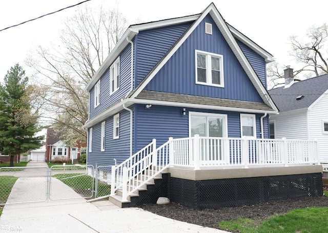 view of front of home with a gate, board and batten siding, and a deck