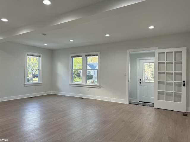 unfurnished room featuring dark wood-type flooring, recessed lighting, and baseboards