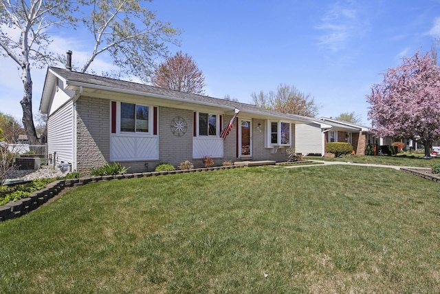 single story home featuring brick siding and a front lawn