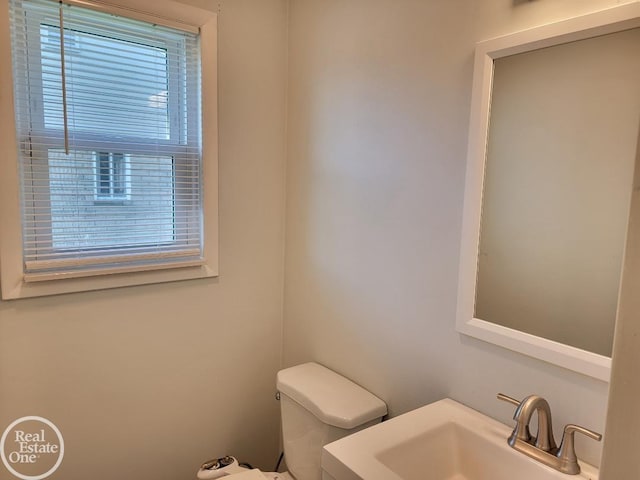 half bathroom with a sink and toilet