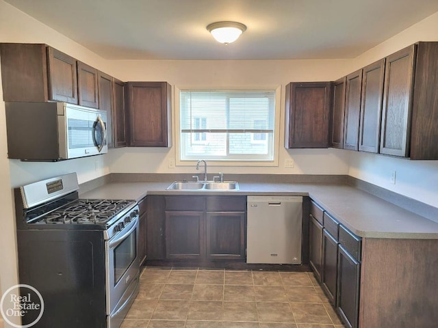 kitchen featuring dark brown cabinetry, appliances with stainless steel finishes, and a sink