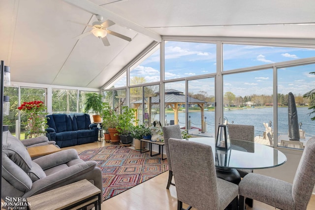sunroom with a water view, lofted ceiling with beams, expansive windows, and wood finished floors