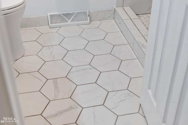 room details with visible vents and a tile shower