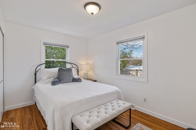 bedroom featuring baseboards and wood finished floors