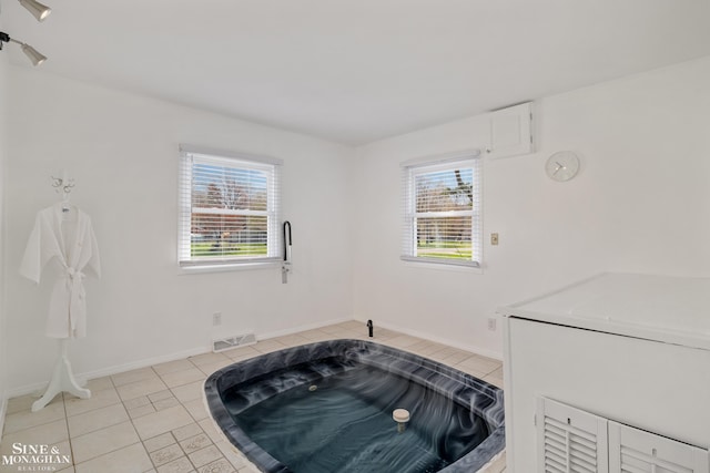 room details with baseboards, a hot tub, and visible vents