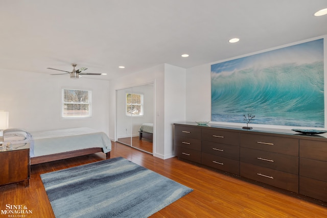 bedroom with ceiling fan, recessed lighting, baseboards, wood finished floors, and a closet