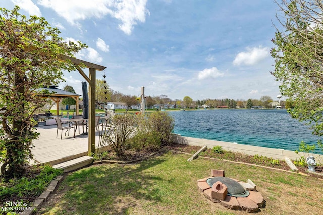 exterior space featuring a gazebo, a water view, and a lawn