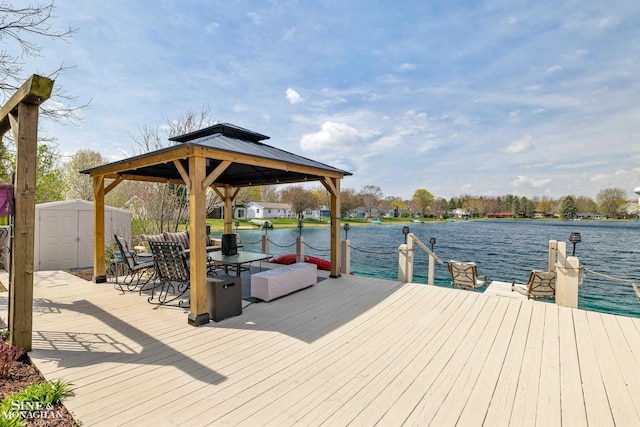 dock area with a gazebo and a water view