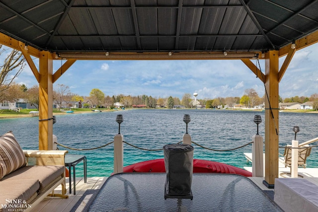 view of dock with a gazebo and a water view