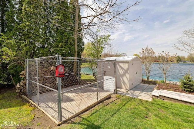 view of gate with an outbuilding, fence, and a yard