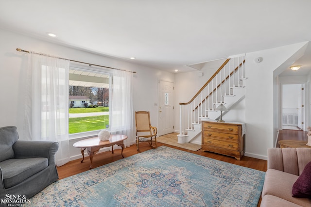 living room with baseboards, recessed lighting, stairs, and wood finished floors