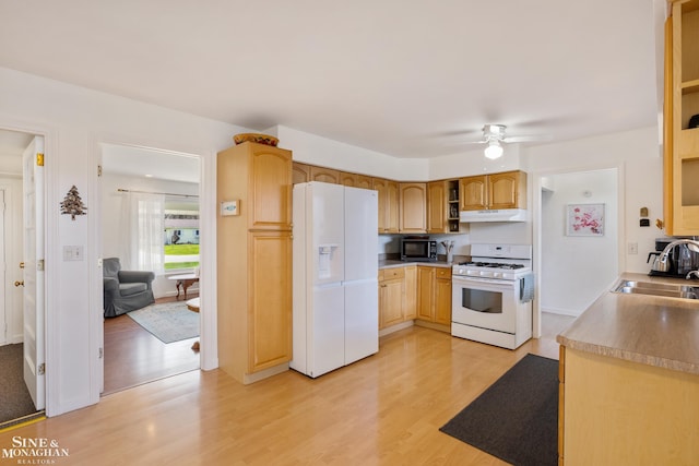 kitchen with open shelves, a sink, white appliances, light wood-style flooring, and under cabinet range hood