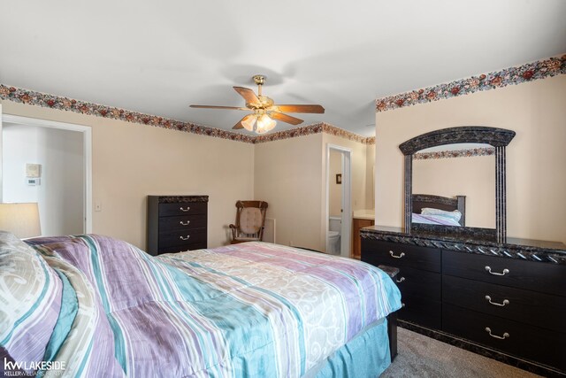 carpeted bedroom featuring connected bathroom and a ceiling fan