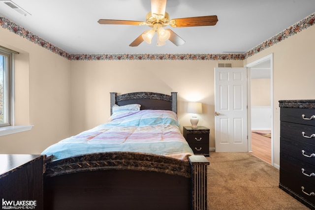 bedroom with carpet floors, ceiling fan, and visible vents