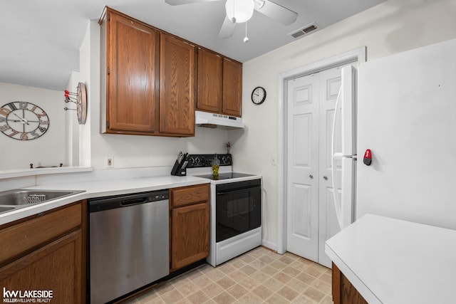 kitchen featuring visible vents, electric range, light countertops, under cabinet range hood, and dishwasher