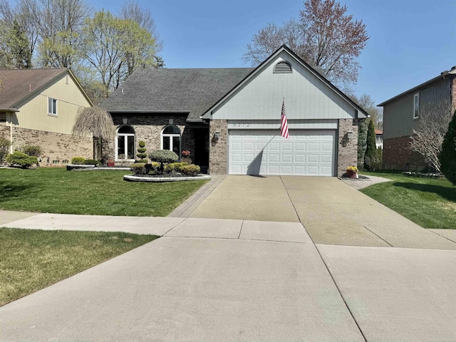 view of front facade with an attached garage, brick siding, a front yard, and concrete driveway