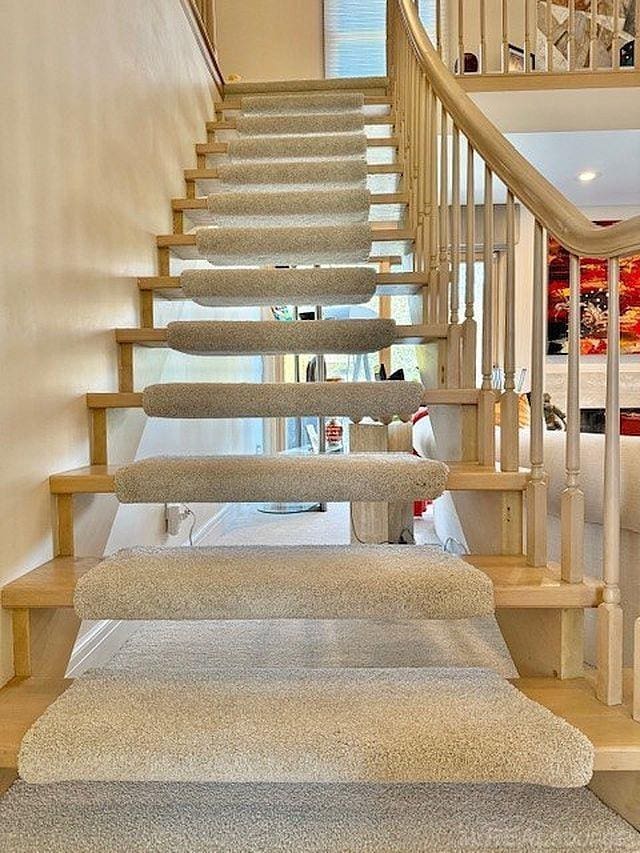 stairs featuring wood finished floors