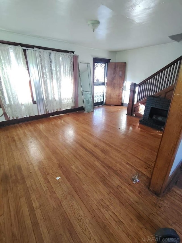 unfurnished living room with hardwood / wood-style flooring