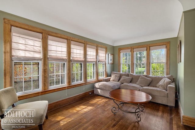 living room with baseboards and wood-type flooring